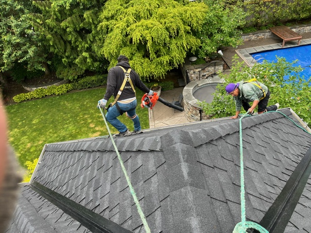 Stout Roofing crew working on a steep composition roof